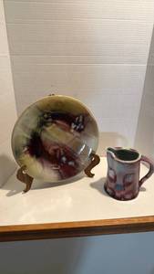 lot 1025 image: Pottery plate on stand with pitcher