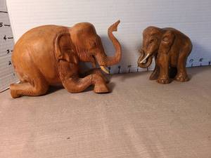 lot 1150 image: Hand Carved Wooden Elephant Figurines Set of 2, foot has been glued on larger elephant