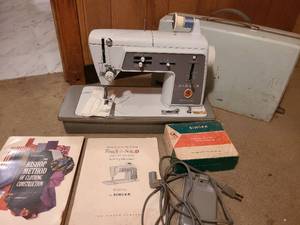 lot 1315 image: Portable Singer Touch and Sew sewing machine in case with accessories.
