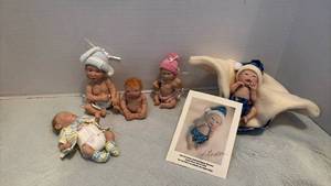 lot 1538 image: Reborn Baby Dolls with Accessories and Certificate. Baby with Knitted Cap and Diapers has broken neck.