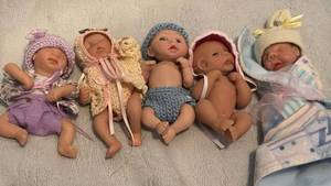 lot 1539 image: Five Polymer Baby Dolls with Knitted Outfits