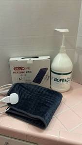 lot 1702 image: Daily Life Electric Heating Pad with Biofreeze Pain Relief Gel. Gel is full only to the black line marked on bottle in picture.