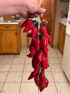 lot 1204 image: Strand of ceramic red chili peppers, 18 inch long