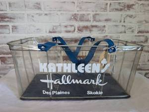 lot 6016 image: Kathleens Hallmark Store Clear Wire Shopping Basket with Blue Handles