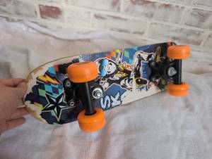 lot 8503 image: Penny Skateboard with Orange Wheels and Graphic Design
