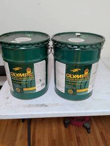 lot 294 image: Olympic Wood Protector Deck Fence Siding Stain 5 Gallon Buckets one bucket is empty the other one has maybe a third to a fourth