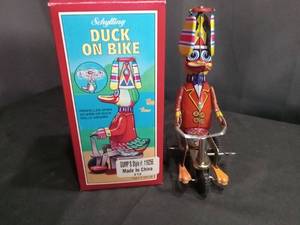 lot 4554 image: Schylling Duck On Bike Wind-Up Tin Toy with Original Box