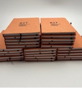 lot 102 image: Lot of 25 RIT Saunders College of Business Leadership Academy Notebook