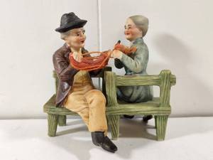 lot 103 image: Lefton Traditional Ceramic Figurine Couple on Green Wooden Bench with Red Basket