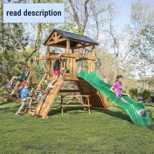 lot 311412 image: Retails for $1599 Backyard Discovery Endeavor II Cedar Wood Swing Set with Wave Slide, Play Deck, Double Rock Wall, Picnic Table, Climbing Wall, Belt Swings, Web Swing, Toy Telescope, Step Ladder, Outdoor Playset