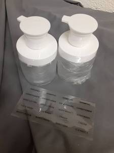 lot 703 image: Two Pack Travel Lotion Dispensers  - Retail $0