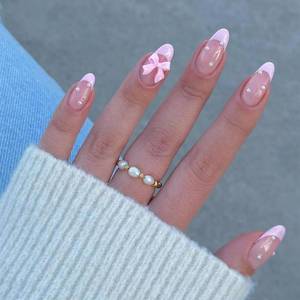 lot 849 image: 24Pcs French Press on Nails Almond Fake Nails with Bow Pearl Design Pink French Tip False Nails Cute Pink Press on Nail Tips Glossy Artificial Nails Acrylic Stick on Nail for Women Manicure - Retail $5