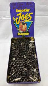 lot 63 image: Smokin Joes Racing Tobacco Tin with Used .38 Brass Casings
