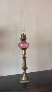 lot 1301 image: 19th-century oil lamp featuring a cranberry-pink, swirled glass