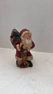 lot 1601 image: Pecan shell wood world Santa figurine holding sack of toys 7 inches tall