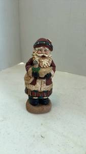 lot 1606 image: Pecan shell wood world Santa figurine holding a goose 6.5 inches tall