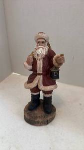 lot 1607 image: Pecan shell wood world Santa figurine holding sack and lantern 10 inches tall
