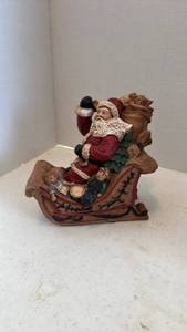 lot 1608 image: Pecan shell wood world Santa figurine in sleigh with toys 7 inches tall