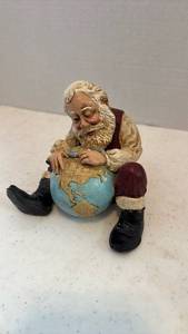 lot 1620 image: Santa figurine looking at globe 4 inches tall