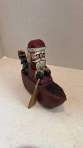 lot 1624 image: Handcrafted wooden Santa Claus figurine rowing a canoe by Lori Miller 6x8