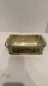 lot 1717 image: Pyrex 213 glass loaf pan with a 1981 Teleflora fruit harvest metal holder