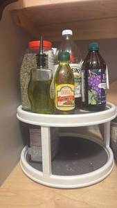 lot 1730 image: White Two-Tier Rotating Lazy Susan Turntable Organizer with black peppercorn, oil and more