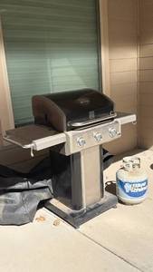 lot 3100 image: Kenmore propane grill with cover and nearly empty tank of propane