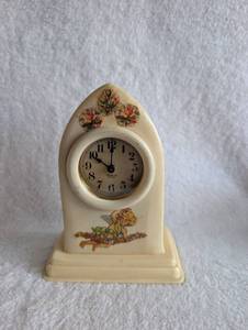 lot 2004 image: Celluloid Mantel Clock with Angel and Floral Design