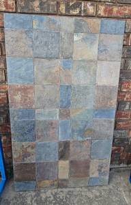 lot 423 image: Stone Tile Table with Metal Edge - Top Only - Tiles are not Removable - Matches Lot 400 - Owners used as a outdoor coffee table using cinder blocks as the legs (not included)