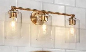 lot 13029 image: LNC Modern 22 in. 3-Light Plated Brass Bath Vanity Light with Clear Glass Shades Powder Room Wall Light - Retail $174