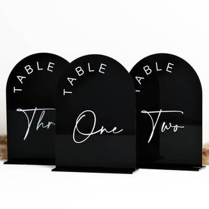 lot 20116 image: Black Arch Wedding Table Numbers with Stands 1-30, 5x7 Inch Black Acrylic Arch Sign with Holder, Arched Acrylic Table Numbers for Wedding Reception (1-30, 5x7)