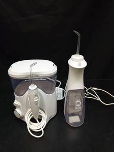 lot 1053 image: Water Flosser and Electric Toothbrush Oral Care Set - Retail $25
