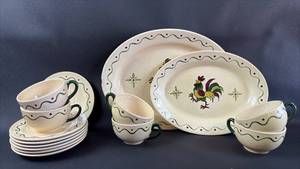 lot 47 image: Poppytrail Metlock Rooster Pattern Dinnerware Set with (7)Saucers (6)Cups and 11 Inch and 14 Inch Serving Platters