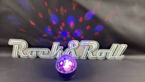 lot 80 image: Rustic Finish 27 inch long Metal Banner and ONN Disco Light Bluetooth Speaker