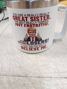 lot 42039 image: Great Sister Novelty Coffee Mug with Lid Political Figure - Retail $8