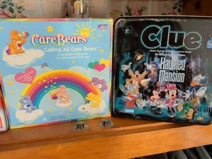 lot 246 image: Classic Board Game Bundle - Care Bears and Disney Clue Haunted Mansion