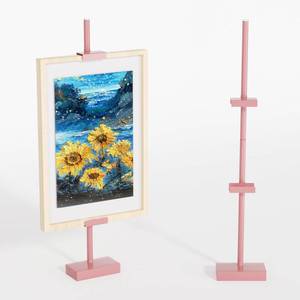 lot 21437 image: Cathyeen Tabletop Picture Frame Stand, Adjustable for Frames Up to 29 H, Frame Holder Stand Table Easels for Display, Metal Standing Easel Display Stand for Picture Frames, Artwork, Canvas (Pink) - Retail $33