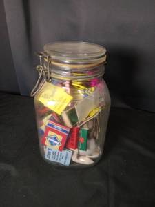 Glass Jar Filled with Assorted Restaurant Matchbooks and Matches