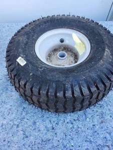 lot 146 image: Lawn Mower Tire and Rim Assembly