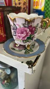 lot 40256 image: Footed Porcelain Teacup and Saucer Set with Rose Design