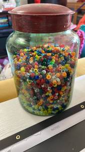 lot 40293 image: Antique Large Green buddled glass Jar Filled with Mixed Seed Beads