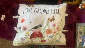 lot 40117 image: Rae Dunn Love Grows Here Floral Canvas Pillow with Tassel Ties