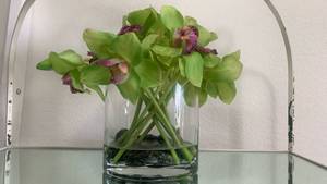 lot 40132 image: Artificial Green and Purple Orchid Flower Arrangement in Clear Glass Vase