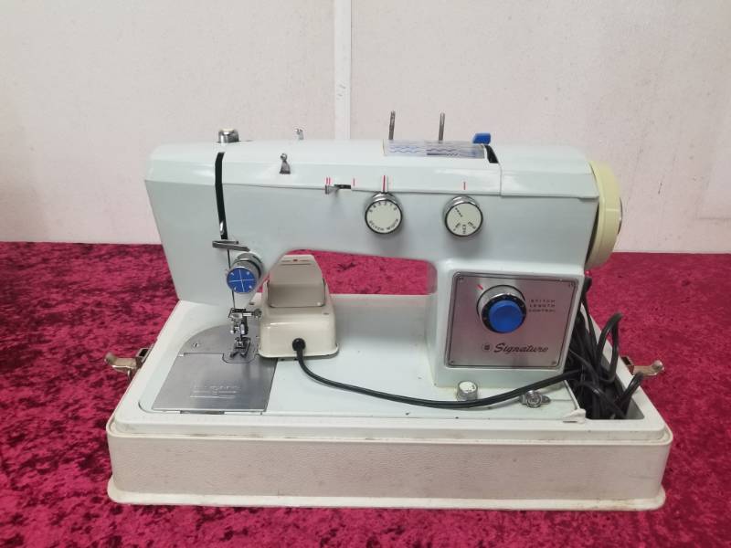 lot 9020 image: Portable Signature Sewing Machine with Case