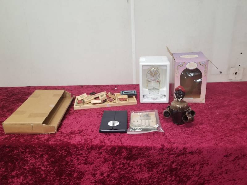 lot 7573 image: Knife Set, Stamp Set, Precious Moments Anniversary Clock, Indian Cup Collectible