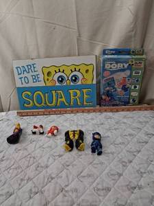 lot 70 image: Mixed Toy Lot with Finding Dory Clay Kit and Action Figures. SPONGE Bob wall decor