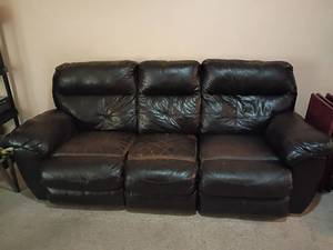 lot 953 image: Faux Leather Couch.  Both ends recline. Worn in the seat area.   37 x 91 x 38