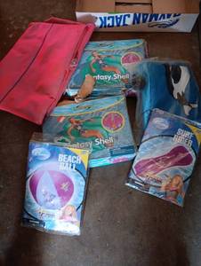 lot 2002 image: 5 different water floats and a Hanna Montana beach ball