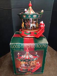 lot 2013 image: Good Times Go Round Musical Christmas Carousel with Santa and Reindeer