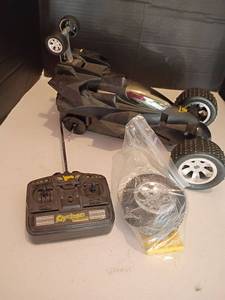 lot 2214 image: Cyclone Revolution RC Car.   Has a tire that needs put on